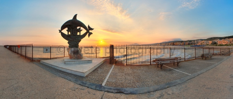 Rethymnon dolphin statue at day break